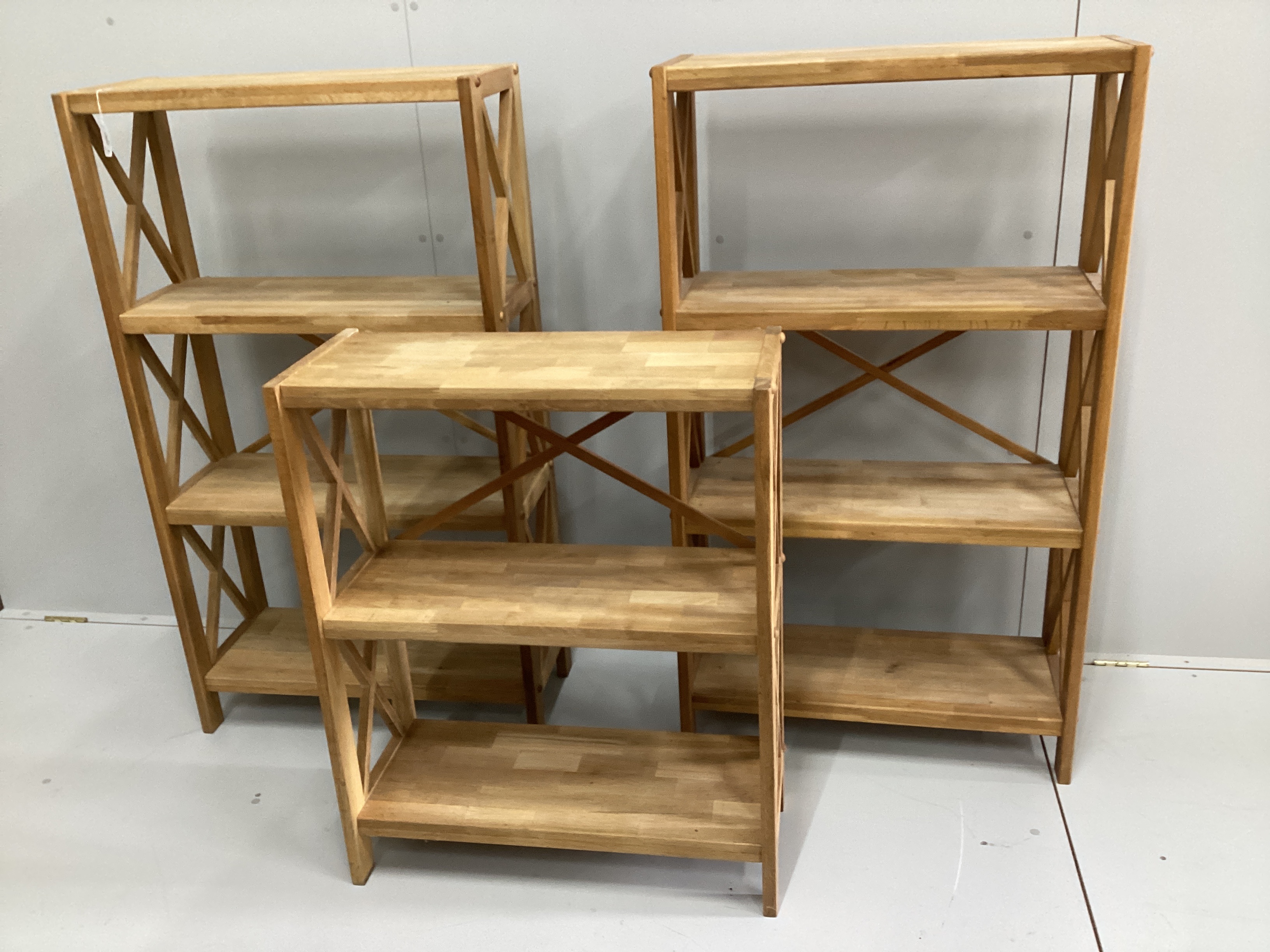 A set of three contemporary oak open bookcases in two sizes, larger width 70cm, depth 30cm, height 124cm
